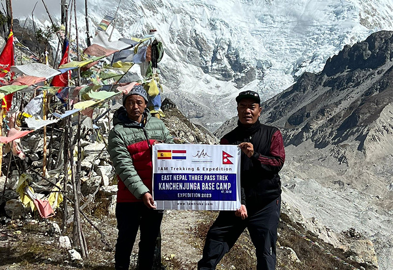 2-men holding banner at Kanchenjunga Base Camp