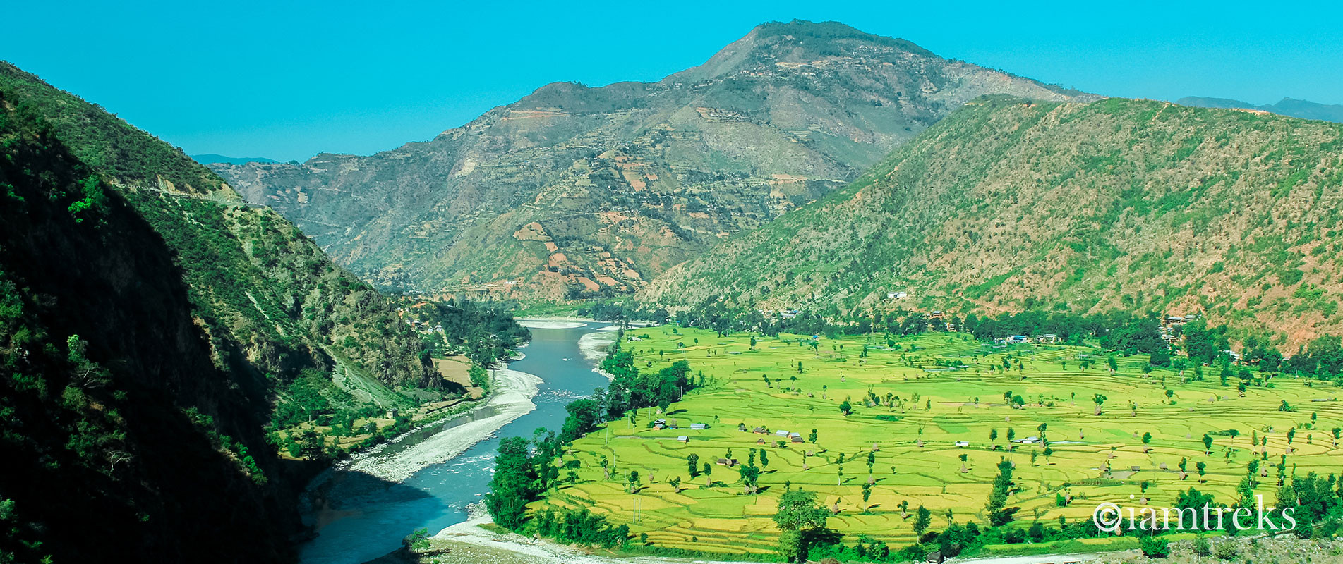 Rolling hills above green paddy fields along the Khimti river basin in Ramechhap Nepal
